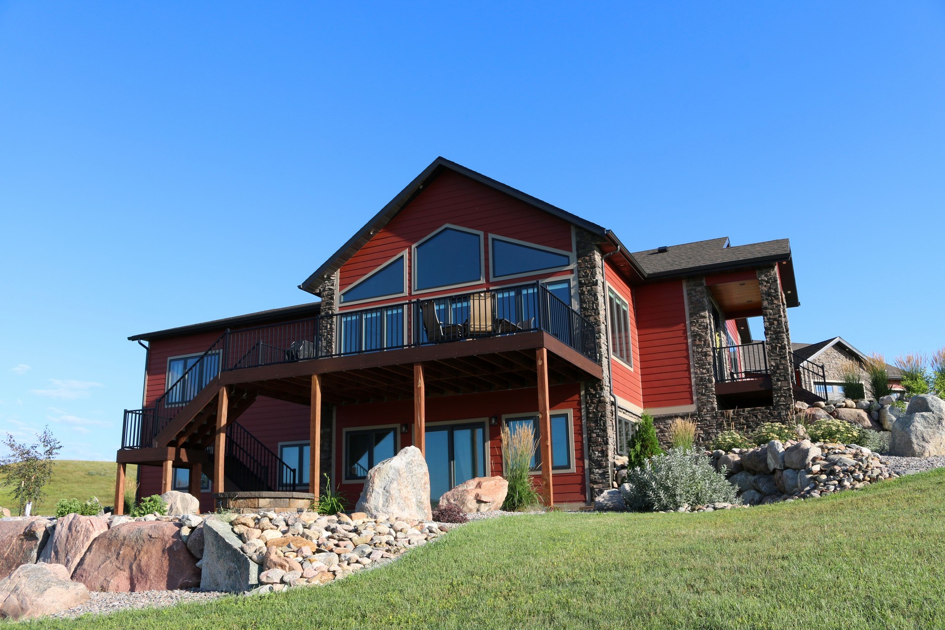 Large Rural Single Family Home Exterior luxury deck with walk out basement patio
